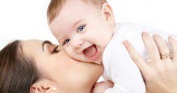 laughing baby playing with mother