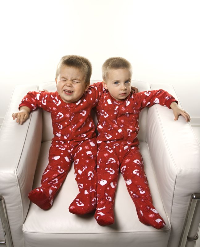 Boy twin brothers sitting together. Boy twin brothers sitting together.