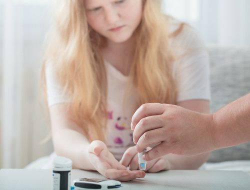 Teen with type 1 diabetes monitors her blood sugar